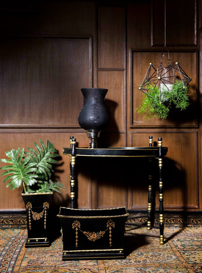 gallery-01 Sophisticated black and gold furniture and decor set against wood paneling in New Delhi
